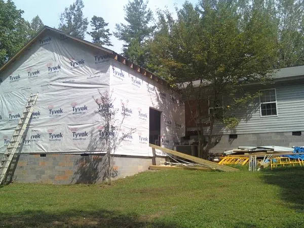 Tyvek wrapped gable on a new room addition beside an existing home in Trenton